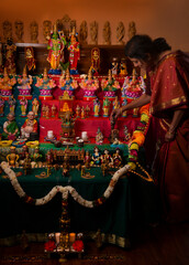 Indian woman arranging golu 