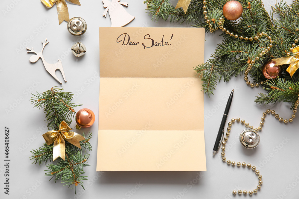 Empty letter to Santa and Christmas decor on grey background
