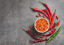 Chili Oil Sauce Chili Peppers Flakes In Oil Dark Background Copy Space. Spicy Condiment.