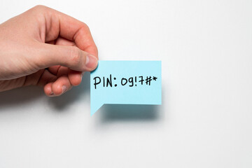 The concept of a pin code written on a piece of paper for a reminder