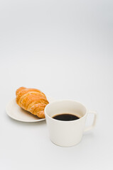 Sticker - sweet and tasty croissant and black coffee cup on white with space for text