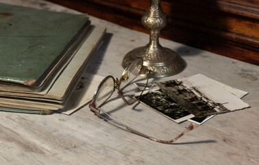 a fragment of an old photo album, glasses and photos