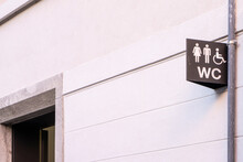 Disabled Toilet Sign On The Wall. Persons With Disabilities Day
