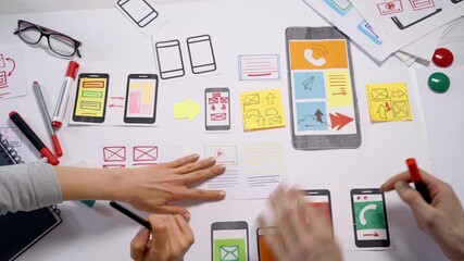 Mobile phone interface applications design concept. Designers create a web project working at a desktop. User experience.