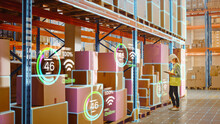 Futuristic Technology Retail Warehouse: Worker Starts Inventory Digitalization With Barcode Scanner Analyzes Goods, Cardboard Boxes, Products. Delivery Infographics In Logistics, Distribution Center
