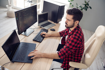 Poster - Photo of concentrated serious young man walk programmer write code pc sit table inside indoors office