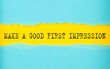 Make a good first impression text on the torn paper , yellow background