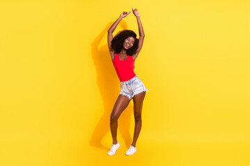 Wall Mural - Full length body size view of attractive cheerful girl dancing having fun isolated over bright yellow color background
