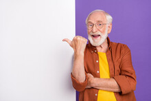 Photo Of Funny Old Man Indicate Empty Space Wearing Eyewear Brown Shirt Isolated Over Purple Color Background