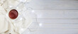 © stopabox - Cup of tea or coffee, knitted white blanket and garland on light wooden background. christmas morning concept. banner