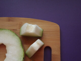 ripe melon cut into slices on a wooden board. High quality photo