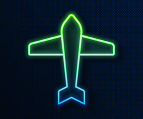 Poster - Glowing neon line Jet fighter icon isolated on blue background. Military aircraft. Vector