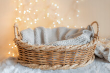 Basket For Baby With Knitted Blanket And Bokeh Background