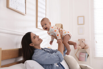 Sticker - Mother with her cute baby on bed at home