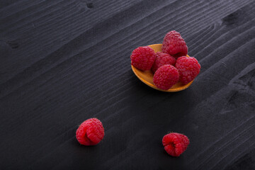 Wall Mural - Fresh raspberry in a wooden plate