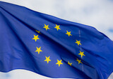 Fototapeta  - Official flag of the European Union in front of a blue sky