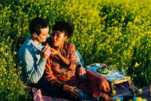 Tender Diverse Couple Having Picnic On Field