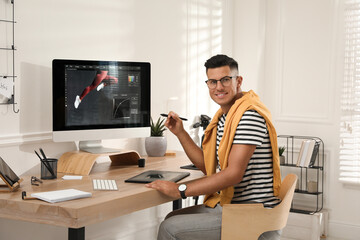 Canvas Print - Professional retoucher working on graphic tablet at desk in office