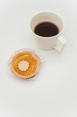 Sticker - apricot jam pastry in a paper backing cup and black coffee cup on white background