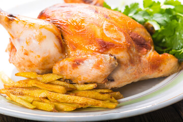 Canvas Print - Fried chicken with potatoes on a plate