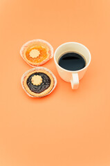 Sticker - delicious apricot and cherry jam pastry in a paper backing cup and black coffee cup on orange