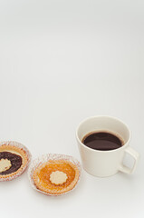 Sticker - apricot and cherry jam pastry in a paper backing cup and black coffee cup on white background