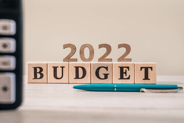 Budget 2022 concept. 2022 budget wooden cubes, calculator and a pen on wooden office table. 2022 budget concept

