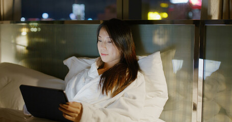 Canvas Print - Woman look at the tablet computer and lying on bed