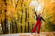 © Serhii - girl with a umbrella, flying on an umbrella, jumping and having fun in a yellow autumn landscape