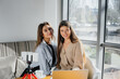 © Andrii - Two young beautiful girls are sitting in a cafe, recording video blogs and communicating on social networks.