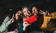 © Vane Nunes - Multiracial friends having fun doing selfie with mobile phone at pizza bar restaurant outdoor - Soft focus on center girl face