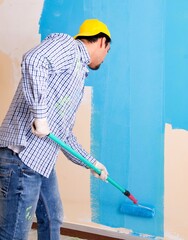 Wall Mural - Painter man painting the wall at home