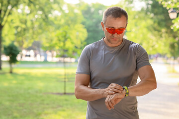 Sticker - Male runner checking pulse outdoors