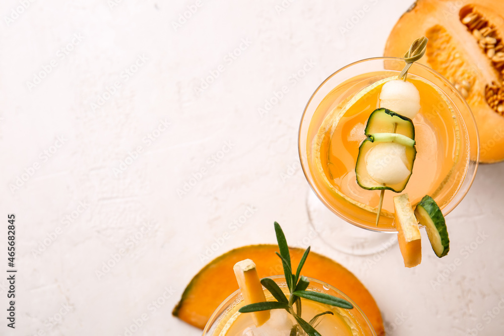 Glass of cold melon cocktail on light background, closeup