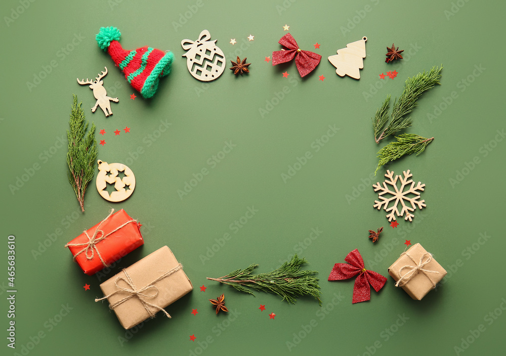 Frame made of coniferous branches, gift boxes and Christmas decorations on color background