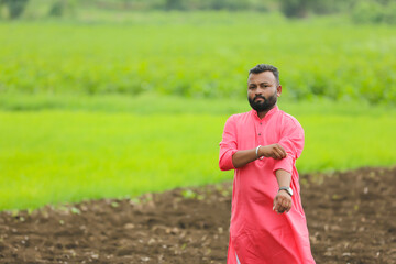 Canvas Print - indian farmer standing at agriculture field.