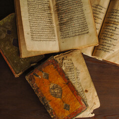 Sticker - Stack of open ancient books in Arabic. Old Arabic manuscripts and texts. Top view