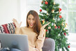 © chinnarach - close up asian woman video call to talking and greeting with friends and family or surprised while get discount from shopping in living room at home for christmas celebration and people technology