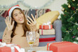 © chinnarach - close up asian woman video call to talking and greeting with friends and family in ornamental living room at home for christmas celebration and people technology concept