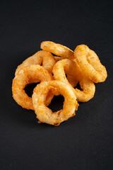 Canvas Print - onion rings on the black background