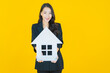 © siraphol - Portrait beautiful young asian woman with house or home paper sign