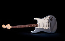 Silver Electric Guitar Isolated On Black Background.