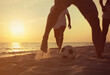 © New Africa - Friends playing football on beach at sunset, closeup