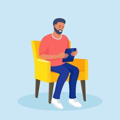 man sitting on a chair and uses tablet pc. internet surfing or reading an article. businessman chatt