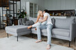 © LIGHTFIELD STUDIOS - man kissing neck of blonde girlfriend with closed eyes in living room