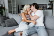 © LIGHTFIELD STUDIOS - young couple with closed eyes kissing in living room