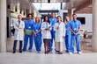 Portrait Of Multi-Cultural Medical Team Wearing Uniform Standing Inside Hospital Building