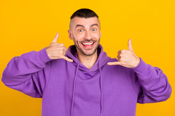 Sticker - Photo portrait young man wearing violet sportswear showing sign call me sign isolated vibrant yellow color background