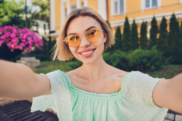 Sticker - Photo of nice young blond lady do selfie wear green blouse spectacles outsite in park