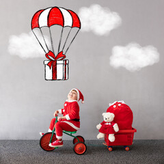 Canvas Print - Happy child riding bike. Christmas holiday concept